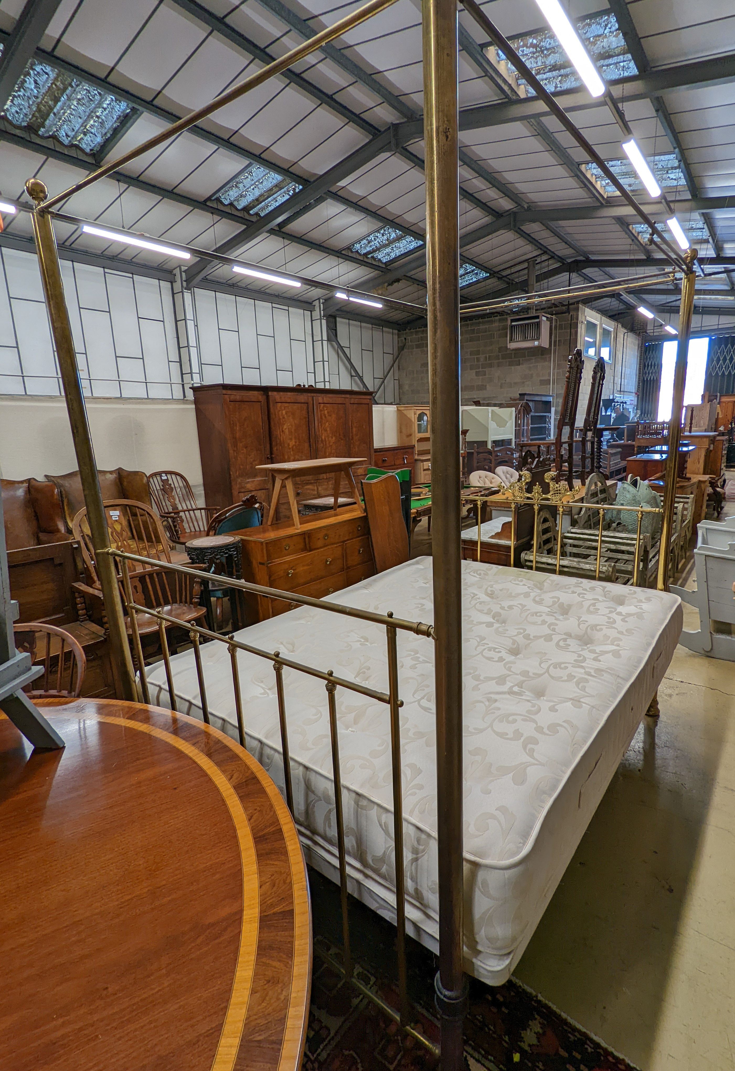 A Victorian style brass four poster double bed frame, with an Odd Mattress Company Hampton 150cm mattress